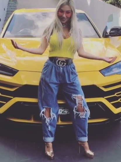 Mrs Nassif’ with the bright yellow Lamborghini she was gifted by her husband. Picture: Instagram