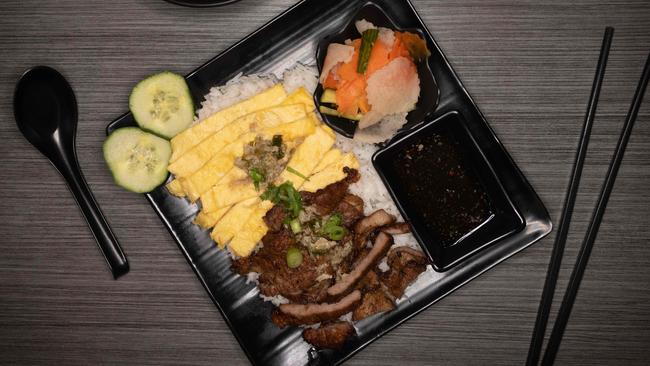 Cambodian fried pork on rice with pickles. Picture: Tony Gough