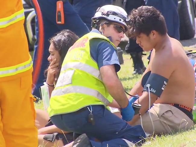 Paramedic attends to two youngsters after the crash. Picture: John Tesoriero