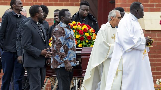 Mourners leave the funeral service at St Andrews Catholic Church in Werribee for Ayuel Akuei and Atem Atem. Picture: Ian Currie