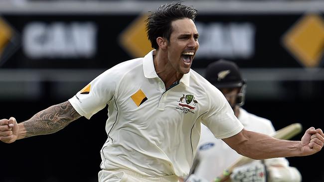 Australia's paceman Mitchell Johnson celebrates his wicket of New Zealand captain Brendon McCullum during day two of the first Test cricket match between Australia and New Zealand in Brisbane on November 6, 2015. AFP PHOTO / Saeed KHAN IMAGE STRICTLY RESTRICTED TO EDITORIAL USE - STRICTLY NO COMMERCIAL USE