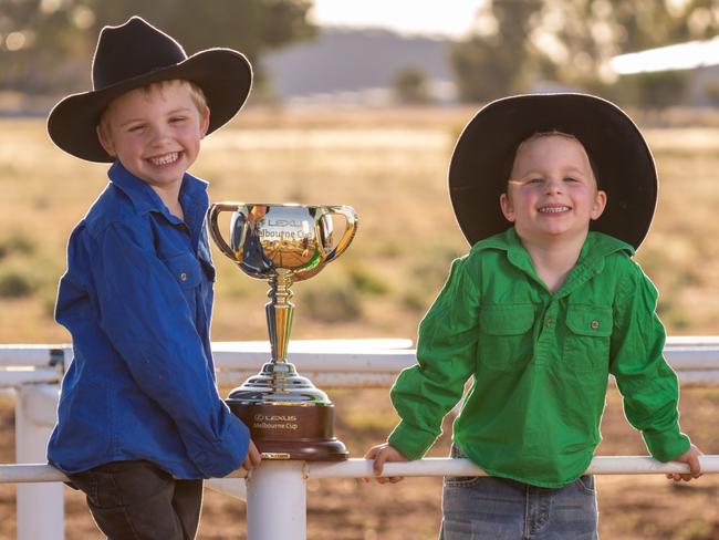 The 2022 Lexus Melbourne Cup Tour in Cloncurry in Queensland. Seth (6) and Arlo (4) OÃ¢â‚¬â„¢Brien with the Cup. Pic Jay Town