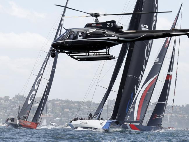 DAILY TELEGRAPH 26TH DECEMBER 2023Pictured on Sydney Harbour is a media chopper filming Andoo Comanche, LawConnect and SHK Scallywag 100 as they race through the heads during the start of the 2023 Rolex Sydney to Hobart Yacht Race.Picture: Richard Dobson