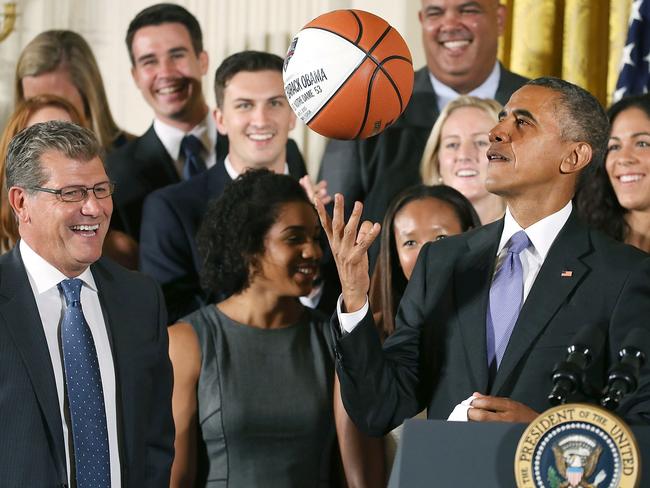 President Barack Obama tosses up a basketball given to him by coach Geno Auriemma (L) while honoring the 2015 NCAA Women’s Basketball Champion University of Connecticut Huskies during a ceremony in the East Room at White House September 15, 2015 in Washington, DC. Picture: Mark Wilson/Getty Images
