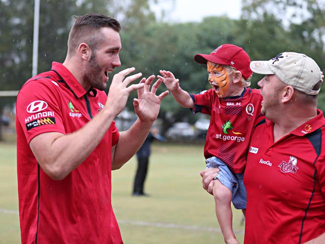 Izack Rodda with a young Reds fan. Picture: Annette Dew