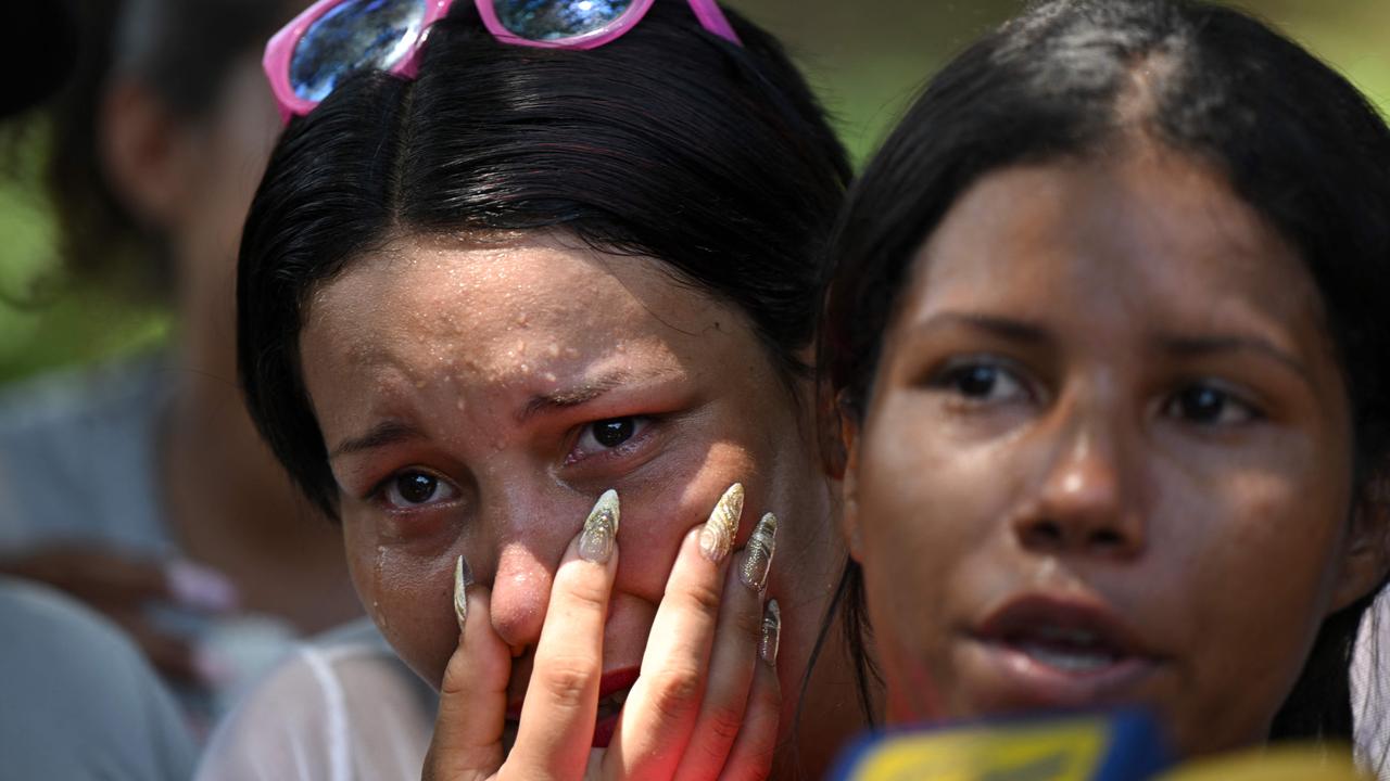 Relatives of inmates wait for news after authorities seized control of the prison. Picture: Yuri Cortez/AFP