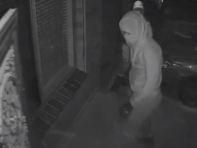 Security camera footage captures the moment two masked men approach the family home. Source: 9News