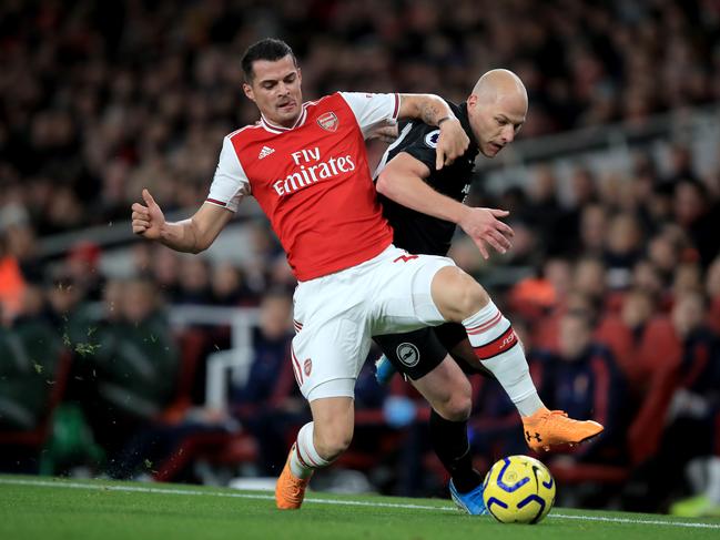 LONDON, ENGLAND - DECEMBER 05: Granit Xhaka of Arsenal in action with Aaron Mooy of Brighton and Hove Albion during the Premier League match between Arsenal FC and Brighton & Hove Albion at Emirates Stadium on December 5, 2019 in London, United Kingdom. (Photo by Marc Atkins/Getty Images)