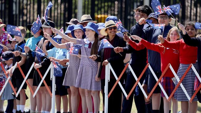 Children wave flags as King Charles III and Queen Camilla arrive for a visit on October 21, 2024 in Canberra, Australia. Picture: Chris Jackson/Getty Images