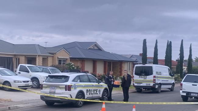 A woman has died in a house fire at Aldinga. It is understood a dog was pulled out of the house alive. Picture: George Yankovich