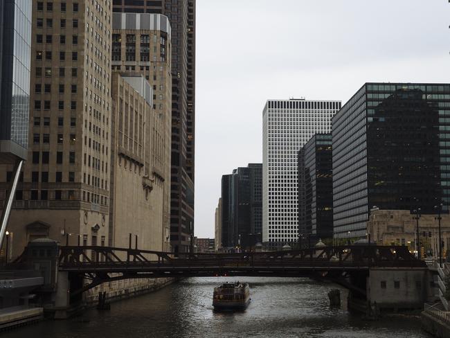 A boat passes under a bridge in downtown Chicago, Illinois, USA. Picture: Angus Mordant for News Corp Australia