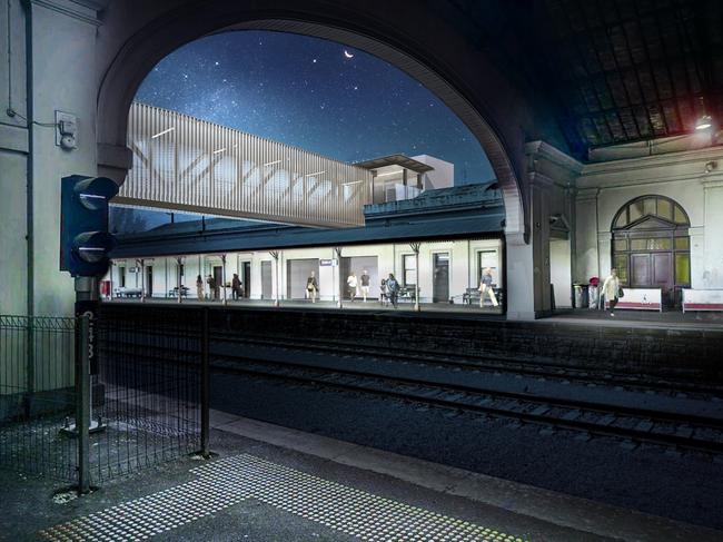 Night-time view of the overpass from inside the train hall.