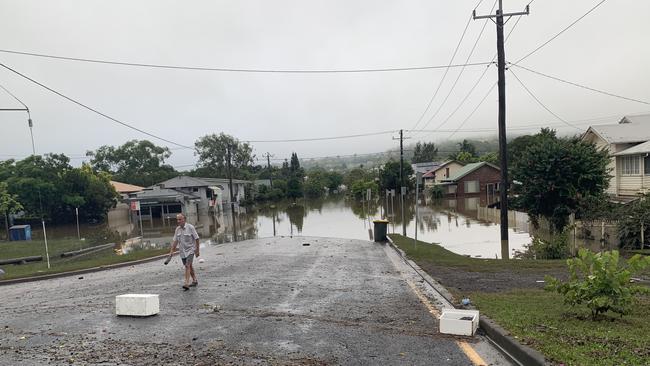 Elwyn Paddison, 80, surveys flood damage to his home at the intersection of Hunter Street and McKenzie Street in Lismore on Tuesday.