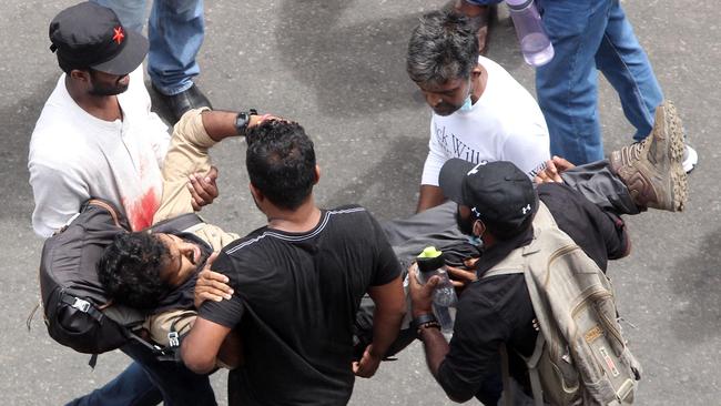 Protestors carry an injured man during a protest demanding the resignation of Sri Lanka's now ex-president Gotabaya Rajapaksa in Colombo on July 9. Picture: AFP