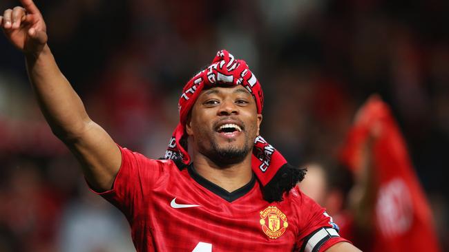 Patrice Evra of Manchester United celebrates winning the Premier League title