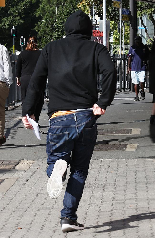 John Anthony Lyons running from Brisbane Magistrates Court. Picture: Liam Kidston