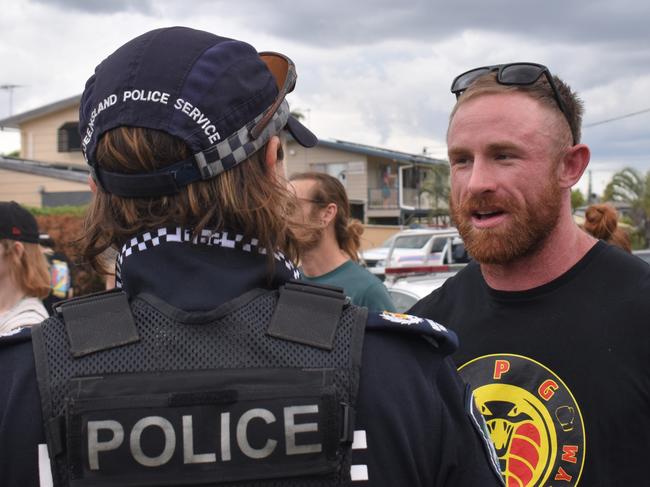 Torin O'Brien speaking with Rockhampton police during the community rally.