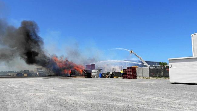 Firefighters battle a fire expected to burn for days after it ignited within about 100 tonnes of compressed cardboard at Carters Transport in the Coolum industrial estate.