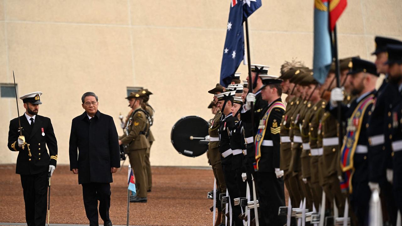 China's Premier Li Qiang inspects a guard of honour during an official welcome ceremony on the forecourt of Australian Parliament House in Canberra. Picture: Lukas Coch/AFP