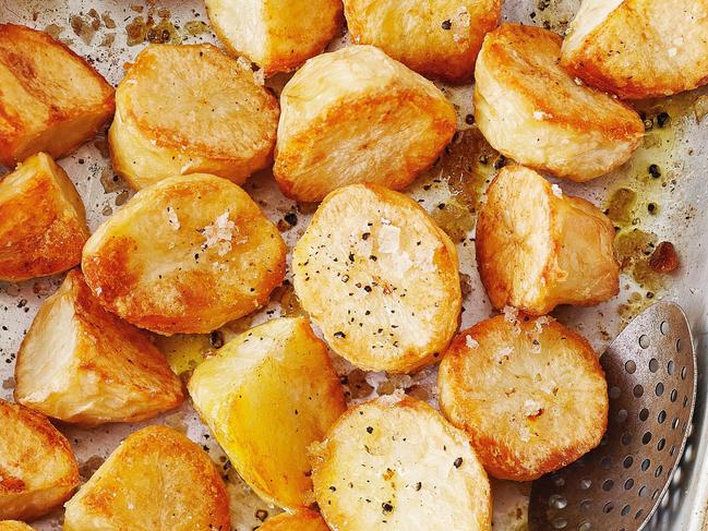 The trick to the ultimate crispy roasted tater is to boil the potatoes first and then dry them out.