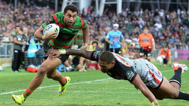 Alex Johnston runs in for a try  for the Rabbitohs as Warrior Manu Vatuvei misses the tackle.