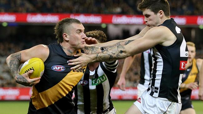 Dustin Martin fends off Collingwood’s Jack Crisp. Picture: Wayne Ludbey