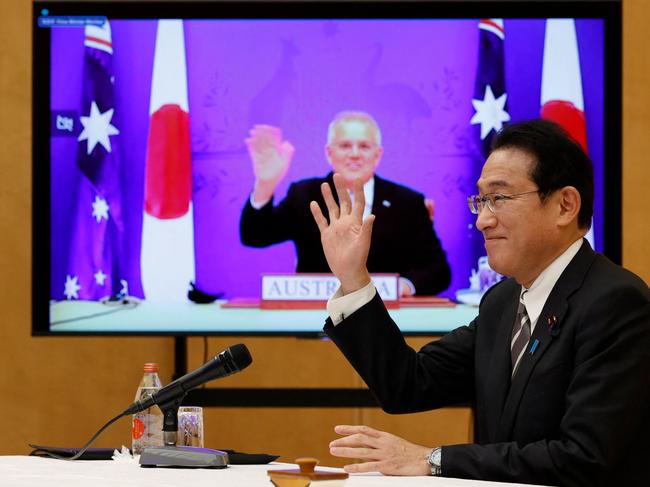 Japan's Prime Minister Fumio Kishida (R) and Australia's Prime Minister Scott Morrison attend a video signing ceremony of the bilateral reciprocal access agreement at Kishida's official residence in Tokyo on January 6, 2022. (Photo by ISSEI KATO / POOL / AFP)