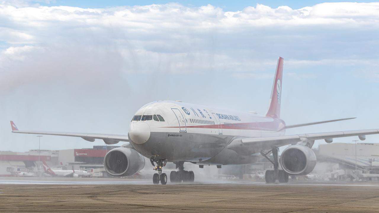 Sichuan Airlines touches down in Sydney on Monday to a water-cannon salute. Picture: Kurt Ams