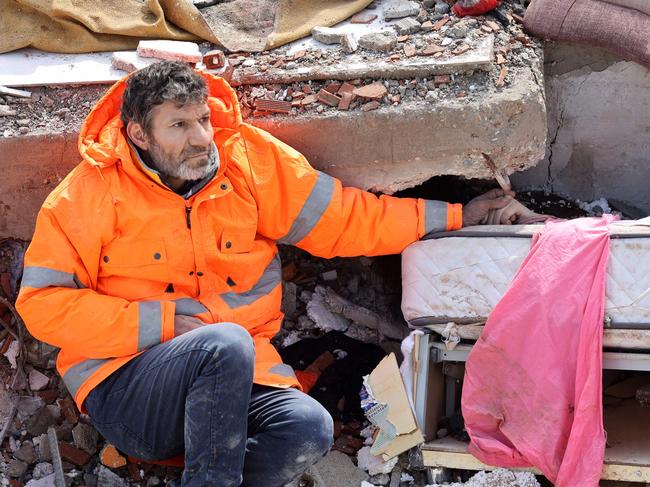 Mesut Hancer holds the hand of his 15-year-old daughter Irmakleyla, who died in the earthquake in Kahramanmaras, close to the quake's epicentre. Picture: AFP