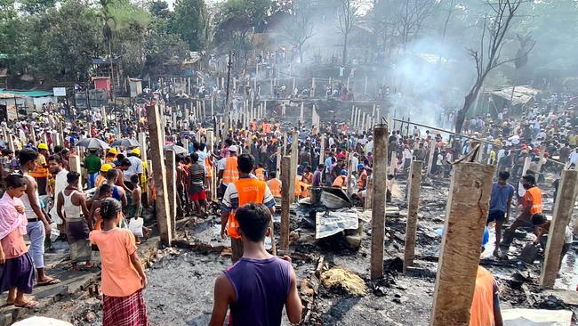 Rohingya refugees look through the debris of their houses charred by a fire at the Ukhia camp in Cox's Bazar on June 1. Picture: AFP