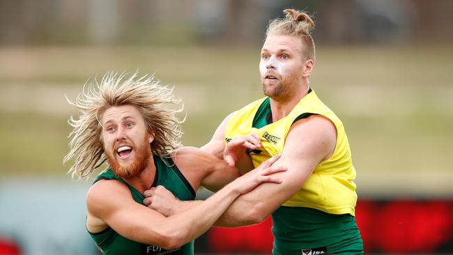 Dyson Heppell, left, and one of Essendon’s big-name recruits Jake Stringer at Bombers training. Picture: Adam Trafford/AFL Media/Getty Images