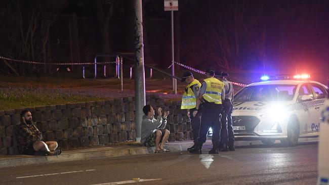 Police speaking to members of the group at the scene. Picture: Gordon McComiskie