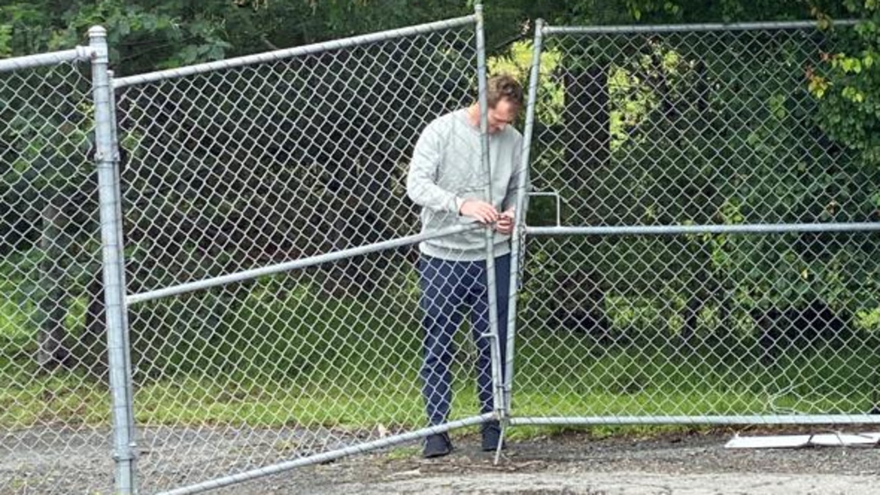 Australian chairman of selectors George Bailey leaves through a back entrance after meeting with Paine at a Hobart ground on Saturday. Picture: James Bresnehan