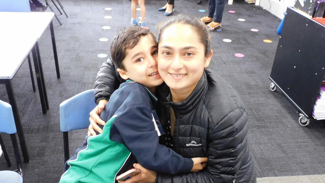 Excited prep student saying goodbye to his mum.