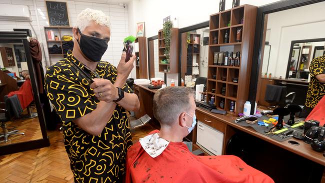 Peter Olsen gives Rod Anderson a haircut at Barber on Degraves as Melbourne opens up. Picture: Andrew Henshaw