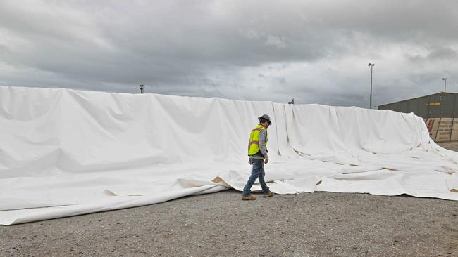 A worker inspects the remains of the giant inflatable storage silo at Hallet Group. Picture: NCA NewsWire / Brenton Edwards