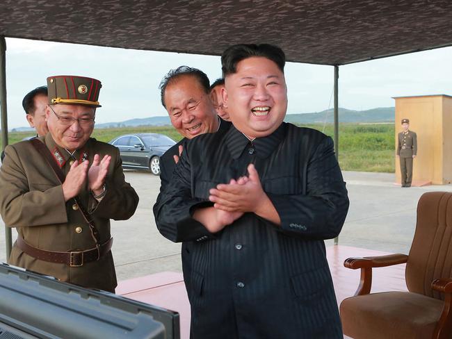 Kim Jong-un celebrates the test launch of an intermediate range Hwasong-12 missile at an undisclosed location in North Korea. Picture: Korean Central News Agency/Korea News Service via AP