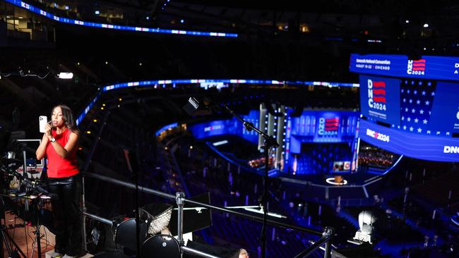 A TV reporter gets ready on the first day of the Democratic National Convention (DNC) at the United Center in Chicago, Illinois.