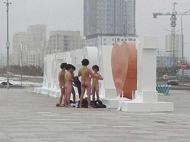 In this image made available by informburo.kz,  on Wednesday Nov. 15, 2017 shows a group of Czech tourists dressed in swimsuits made famous by TV and film character Borat in Atana,  Friday Nov. 10, 2017.  The group of six Czech tourists who visited Kazakhstan dressed up in  the skimpy swimsuits  have reportedly been detained by authorities in the central Asian country's capital Astana. Sporting lime green "mankinis" and black wigs, the men had hoped to take a picture in front of the "I Love Astana" sign. But local police detained them on Friday and fined them 22,500 tenge ($68) each, according to the Kazakh news website informburo.kz. (informburo.kz, via AP)