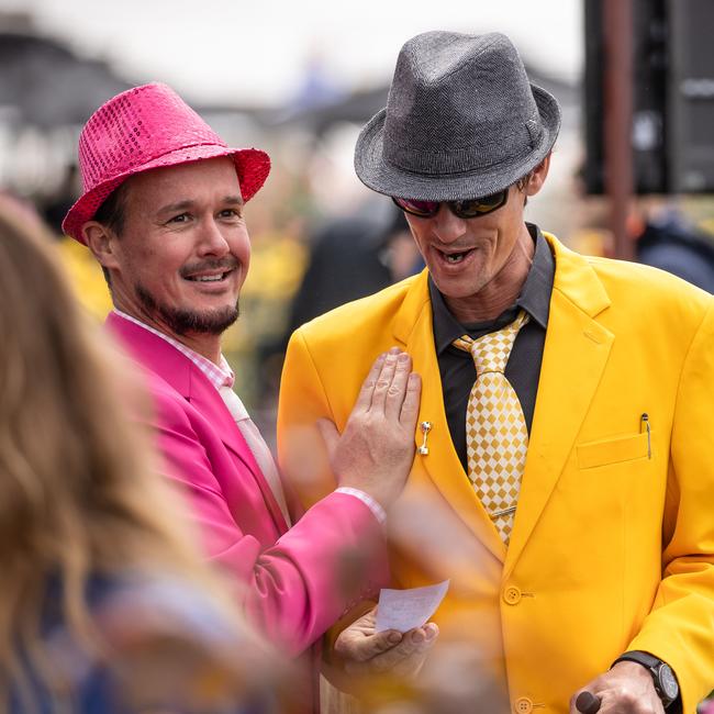 Two colourful punters caught in the rain Picture: Jason Edwards