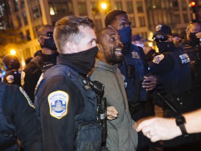 Police arrest a man during a protest outside the White House.