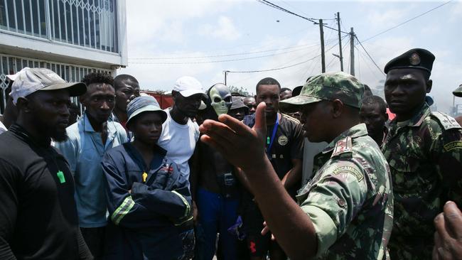 Mozambican soldiers negotiate with protesters during a demonstration against the government on December 6. Picture: Amilton Neves / AFP