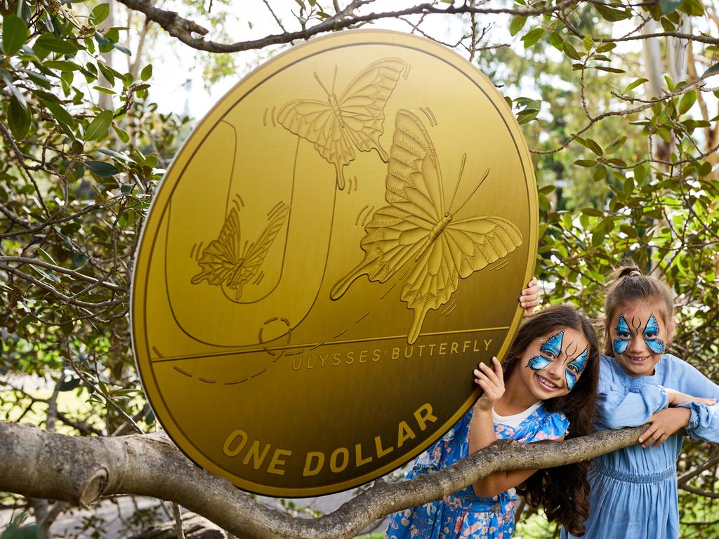 Mila, pictured at right, and Lucy, both 7, pose with a giant version of the U for Ulysses butterfly $1 coin, part of the A-Z of Aussie icons in the Great Aussie Coin Hunt. Picture: Australia Post/David Swift.