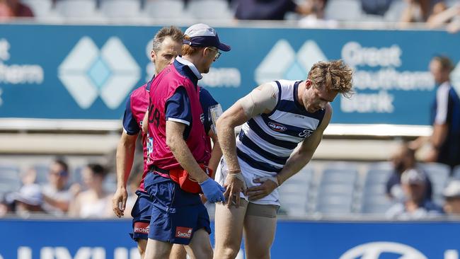 Geelong midfielder Cameron Guthrie was assisted by trainers after injuring his groin in the opening minute at Ikon Park against Carlton on Thursday. Picture: Michael Klein