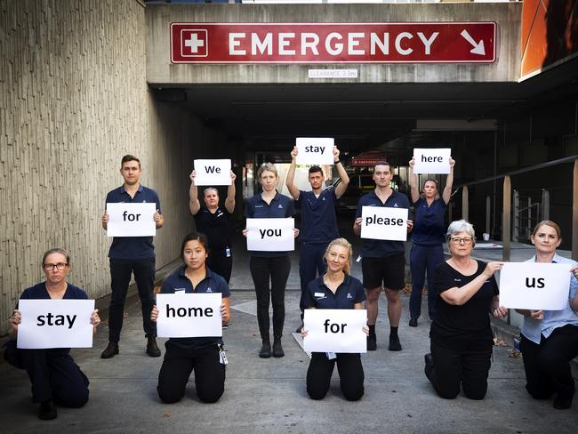 Nursing and Allied Health staff with their message, We Stay Here For You Please Stay Home For Us at the Royal Hobart Hospital. Picture Chris Kidd