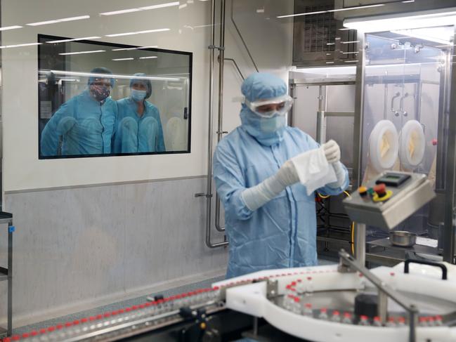 Prime Minister Scott Morrison and Health Minister Greg Hunt (at left, though the window) visit the CSL plant responsible for making and delivering the AstraZeneca Covid-19 vaccine in Melbourne back in February. Picture: Adam Taylor PMO Via NCA NewsWire