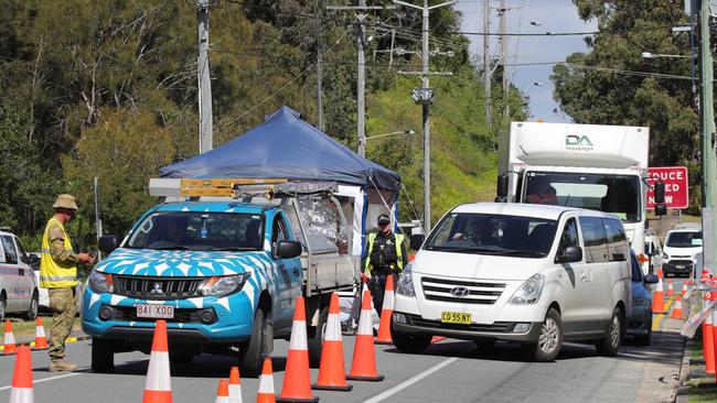 Police and ADF officers at a border checkpoint at Miles St in Coolangatta. Picture: Glenn Hampson.