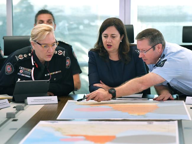 Queensland Fire and Emergency Services Commissioner, Katarina Carroll (left), Queensland Premier Annastacia Palaszczuk (centre) and Queensland Police Deputy Commissioner Bob Gee (right) are seen during a meeting of the Queensland Disaster Management Committee in response to Tropical Cyclone Trevor. Picture: AAP Image/Darren England