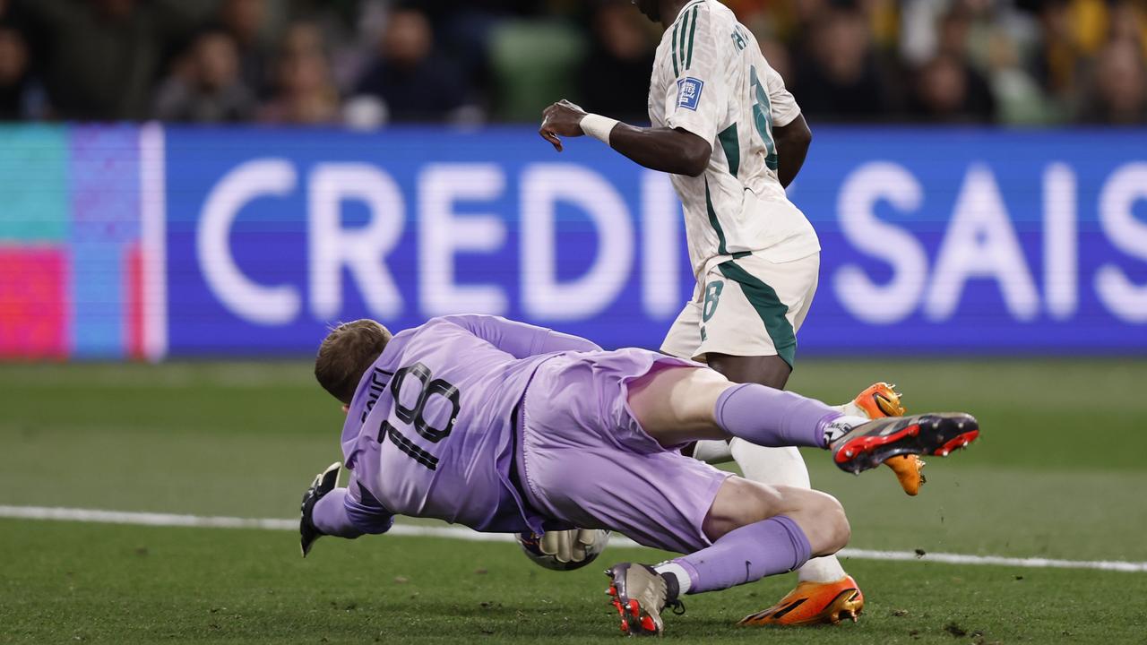 Joe Gauci dives to make a save during the first half of the World Cup qualifying clash at Melbourne Rectangular Stadium. Picture: Darrian Traynor / Getty Images