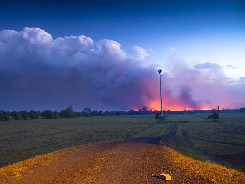 Smoke and fire is seen in the distance near Rainbow Flats, NSW, last night. Picture: AAP Image/Shane Chalker